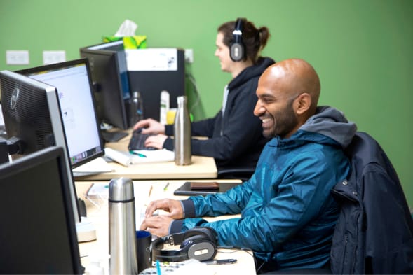 Two men working independantly on adjacent desks